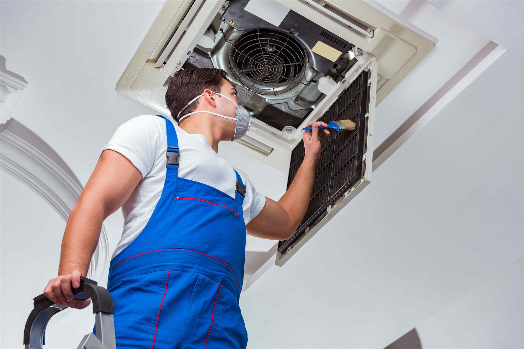 Technician servicing an air conditioning unit